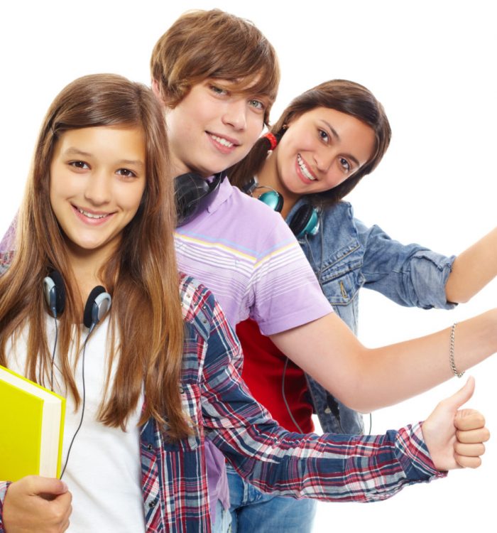 Row of teens with headphones showing thumbs up and smiling at camera