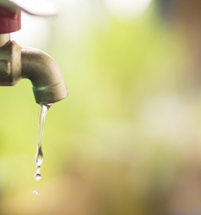 close up water drop from tab, leaking water, save water and water conservation concept